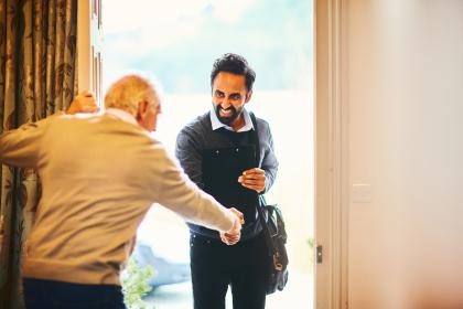 Customer greeting a moving service consultant at the door.