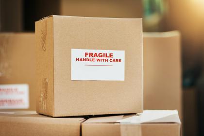 Packed moving boxes labelled 'Fragile, Handle with Care'