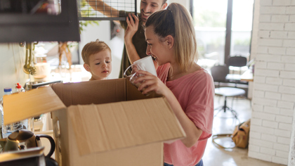 Young Family with Young Boy Unpacking Essentials