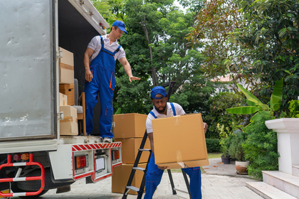 Professional moving company man holding moving box